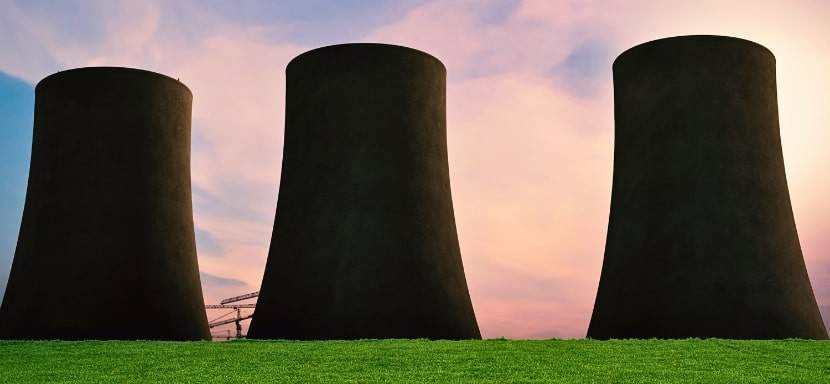 Nuclear cooling towers in the middle of a field.