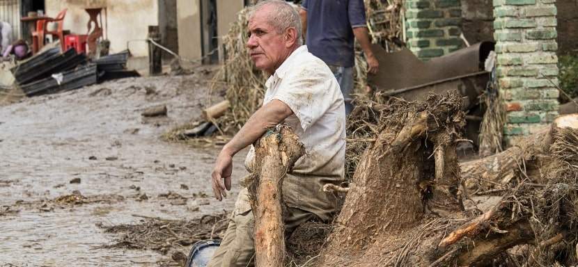 Flood survivor resting while trying to help with clean up after a massive flood.