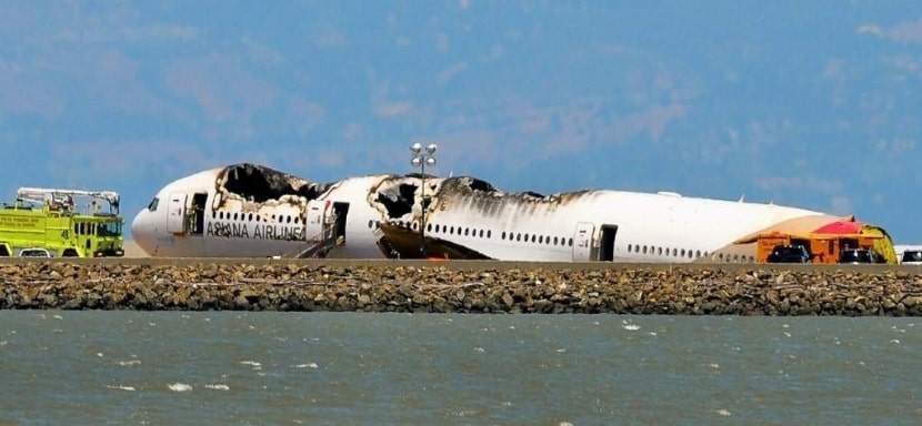 A plane crash site at the end of a runway.