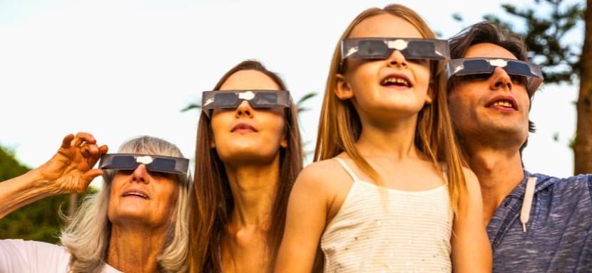 People using special glasses to watch a solar eclipse safely.