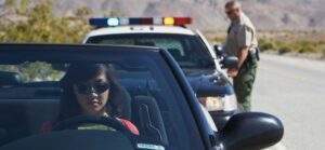 A calm afternoon traffic stop with a police officer approaching a civilian car, symbolizing a respectful law enforcement encounter.