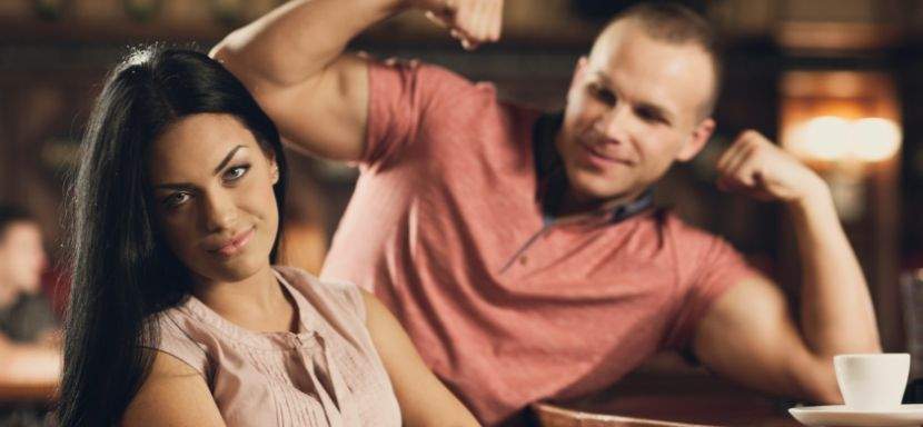 A person looking uncomfortable on a date at a café, glancing at the camera.